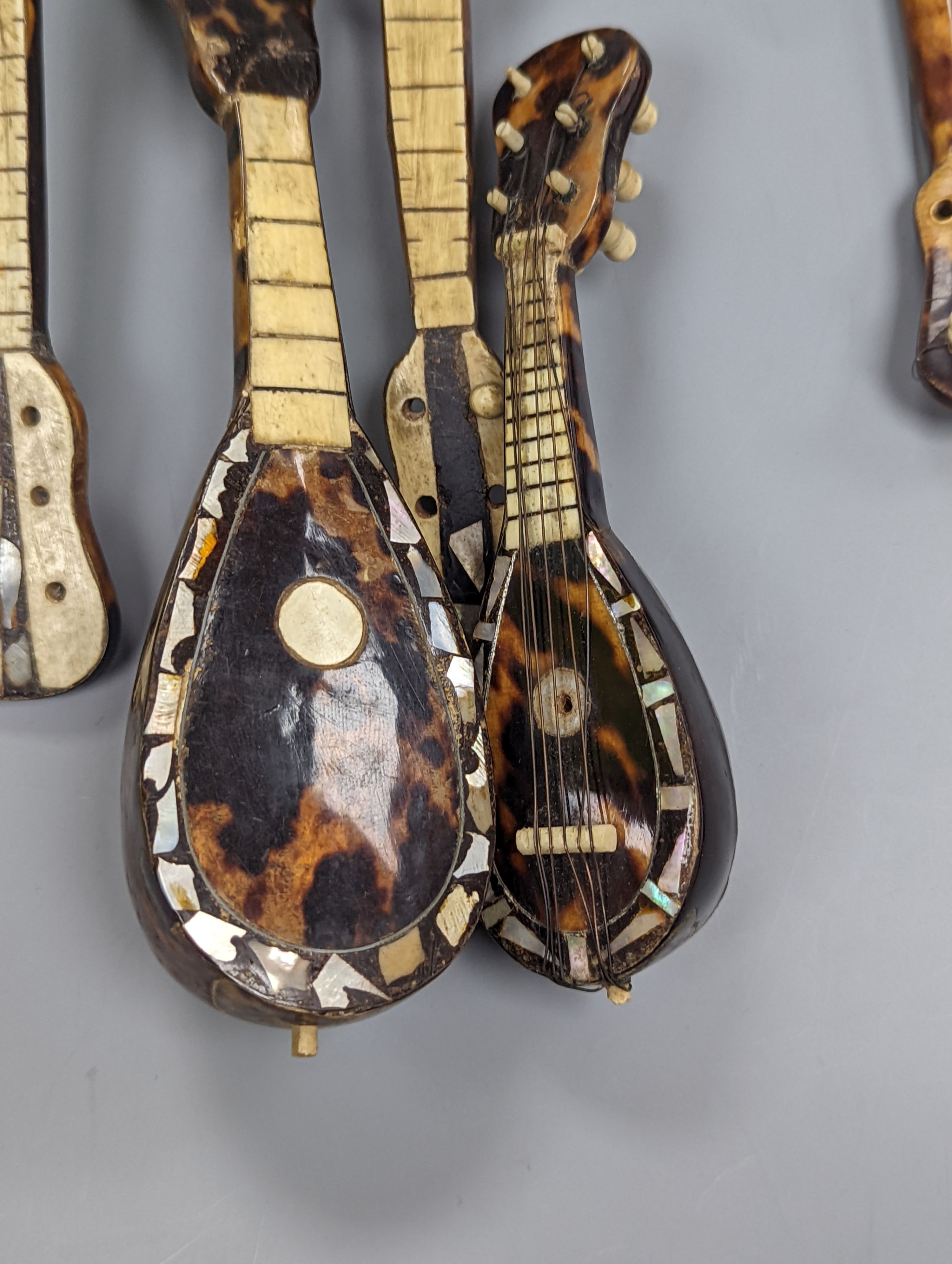 Five 19th century tortoiseshell miniature stringed instruments, longest 20cm.